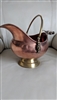 Vintage footed ash coal copper and brass basket with porcelain handle and lion heads handle base.