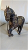 Primitive art antique hand carved ornate horse statue with brass and copper accents in Mediterranean or Middle East style.