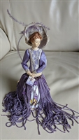 Victorian style porcelain doll with tassle dress