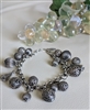 Vintage Rachel silver tone charm bracelet with filigree spheres and cone pendants