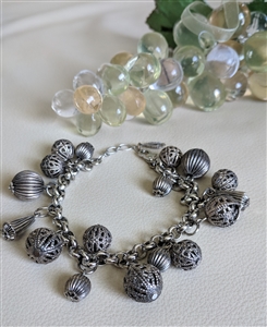 Vintage Rachel silver tone charm bracelet with filigree spheres and cone pendants