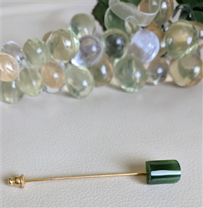Vintage green stone hat pin with gold tone metal and rectangular stone showing light chip on back