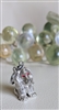 Vintage Monet silver tone sitting dog charm with red enamel eyes and satin finish