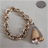 Vintage 1970s 1980s Napier gold tone chain bracelet with bell charm and crystal accent