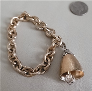Vintage 1970s 1980s Napier gold tone chain bracelet with bell charm and crystal accent