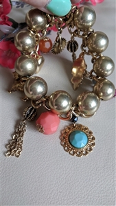 Vintage gold tone chunky stretch charm bracelet with colorful plastic beads and dangles