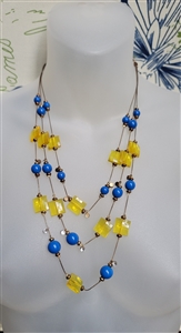 Womens vintage 1991 cascading blue and yellow beaded necklace costume jewelry piece on display form