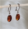 pair of preowned vintage 1990s honey baltic amber oval cabochon sterling silver dangle earrings with secure french wire latches