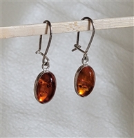 pair of preowned vintage 1990s honey baltic amber oval cabochon sterling silver dangle earrings with secure french wire latches