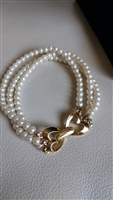 Monet three strand faux ivory pearl bracelet with gold tone double heart clasp