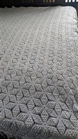 Vintage mid century American mill woven bedspread in a starlike geometric design with long fringes one hundred and six inches long