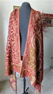 Handmade wool shawl with red floral and yellow geometric patterns from India draped on a mannequin.