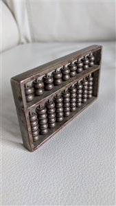 Vintage heavy brass and bronze miniature abacus with detailed beads and sturdy metal frame showing preowned wear