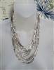 Silver tone 14 strand cascading liquid metal bead collar necklace with woven end caps