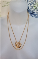 Vintage gold tone snake chain necklace with three interlocking openwork heart pendants