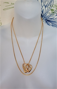 Vintage gold tone snake chain necklace with three interlocking openwork heart pendants