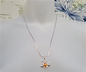 new old stock 1970s libra zodiac scales pendant with genuine cognac baltic amber cabochon and 21 inch sterling silver chain