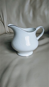 Wedgwood Silver Ermine bone china creamer pitcher in Contour shape with white embossed florals and platinum trim from the 1960s
