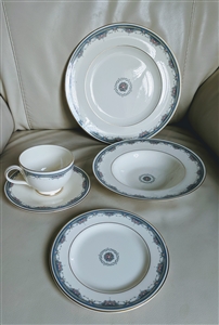 Five piece vintage 1986 Royal Doulton Albany bone china place setting with blue and yellow floral borders and gold trim on a cream ground