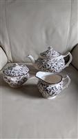 Johnson Brothers Susanna Brown three piece ironstone tea set featuring a teapot lidded sugar bowl and creamer with intricate brown floral transferware from the 1950s