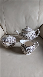 Johnson Brothers Susanna Brown three piece ironstone tea set featuring a teapot lidded sugar bowl and creamer with intricate brown floral transferware from the 1950s