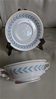 Vintage 1946 Syracuse China Sherwood Old Ivory footed cream soup bowl with two handles and matching saucer featuring blue laurel design and gold trim