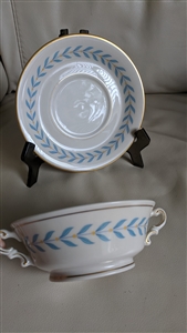 Vintage 1946 Syracuse China Sherwood Old Ivory footed cream soup bowl with two handles and matching saucer featuring blue laurel design and gold trim