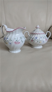 Johnson Brothers Summer Chintz white earthenware lidded sugar bowl and creamer set with multicolor floral pattern and pink scalloped rim