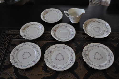 Eight piece vintage Arcadia by Syracuse Old Ivory porcelain set featuring floral swags and gold accents including plates saucers and a creamer