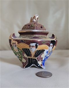 Japanese Satsuma porcelain tri footed Koro incense burner with Foo Dog lid finial and hand painted figures