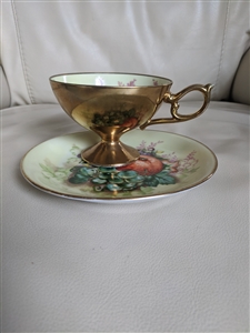 Porcelain teacup and saucer from Maruichi Japan colorful grapes design gold tone exterior