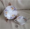 George Proctor Co Gladstone Iris teacup and saucer in colorful florals over white porcelain