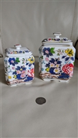 Set of two vintage Japanese footed bisque porcelain lidded jars in two sizes with hand painted village scenes