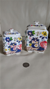 Set of two vintage Japanese footed bisque porcelain lidded jars in two sizes with hand painted village scenes