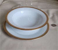 Two piece vintage Noritake Goldridge 5480 porcelain set featuring a rim soup bowl and salad plate with thick gold encrusted geometric bands and lines