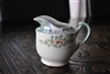 Japanese hand painted iridescent lusterware porcelain creamer pitcher with green border and pink flowers from the 1920s