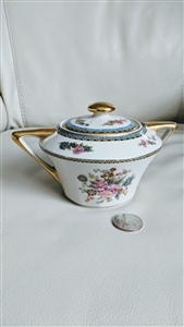 Chas Field Haviland Limoges France porcelain lidded sugar bowl featuring floral bouquets blue and gold borders and gold handles from the 1920s