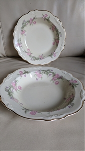 Pair of vintage Homer Laughlin Virginia Rose rim soup bowls with embossed rose medallions and pink and purple floral sprays on ivory porcelain