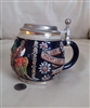 Vintage Marzi and Remy German beer stein in deep cobalt blue with embossed tavern scene and pewter lid