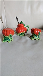 Three piece vintage Japanese porcelain pumpkin salt and pepper shakers with a lidded marmalade jam jar on green leaf bases