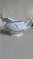 Bavarian white porcelain creamer pitcher with embossed wheat stalks, wild daisies, and gold trim from the 1950s