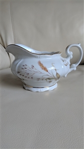Bavarian white porcelain creamer pitcher with embossed wheat stalks, wild daisies, and gold trim from the 1950s