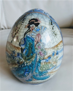 Satsuma style porcelain egg featuring hand painted Geisha holding fan with raised Moriage floral details and crackle glaze