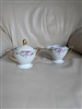 Pirkenhammer Austrian porcelain creamer pitcher and lidded sugar bowl set with pink rose florals and gold gilt handles from the 1900s
