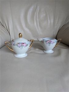 Pirkenhammer Austrian porcelain creamer pitcher and lidded sugar bowl set with pink rose florals and gold gilt handles from the 1900s