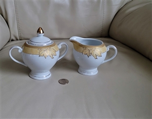 Casati German white porcelain creamer pitcher and lidded sugar bowl set with golden leaves and gold finial lid