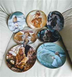 A collection of seven Thornton Utz vintage porcelain plates featuring portraits of young girls shown from the front and back