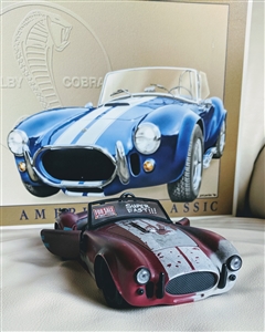 preowned Jada Toys 1965 Shelby Cobra 427 SC car model and 1966 Shelby Cobra tin sign modern display
