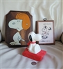 Three piece vintage Peanuts set with a plastic Snoopy bottle a hand painted wood plaque and a Corton Sproke decoupage plaque