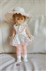 Vintage hard plastic body doll with rubber head, 14 inches tall.